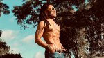 Lenny Kravitz showing his upper body physique outdoors